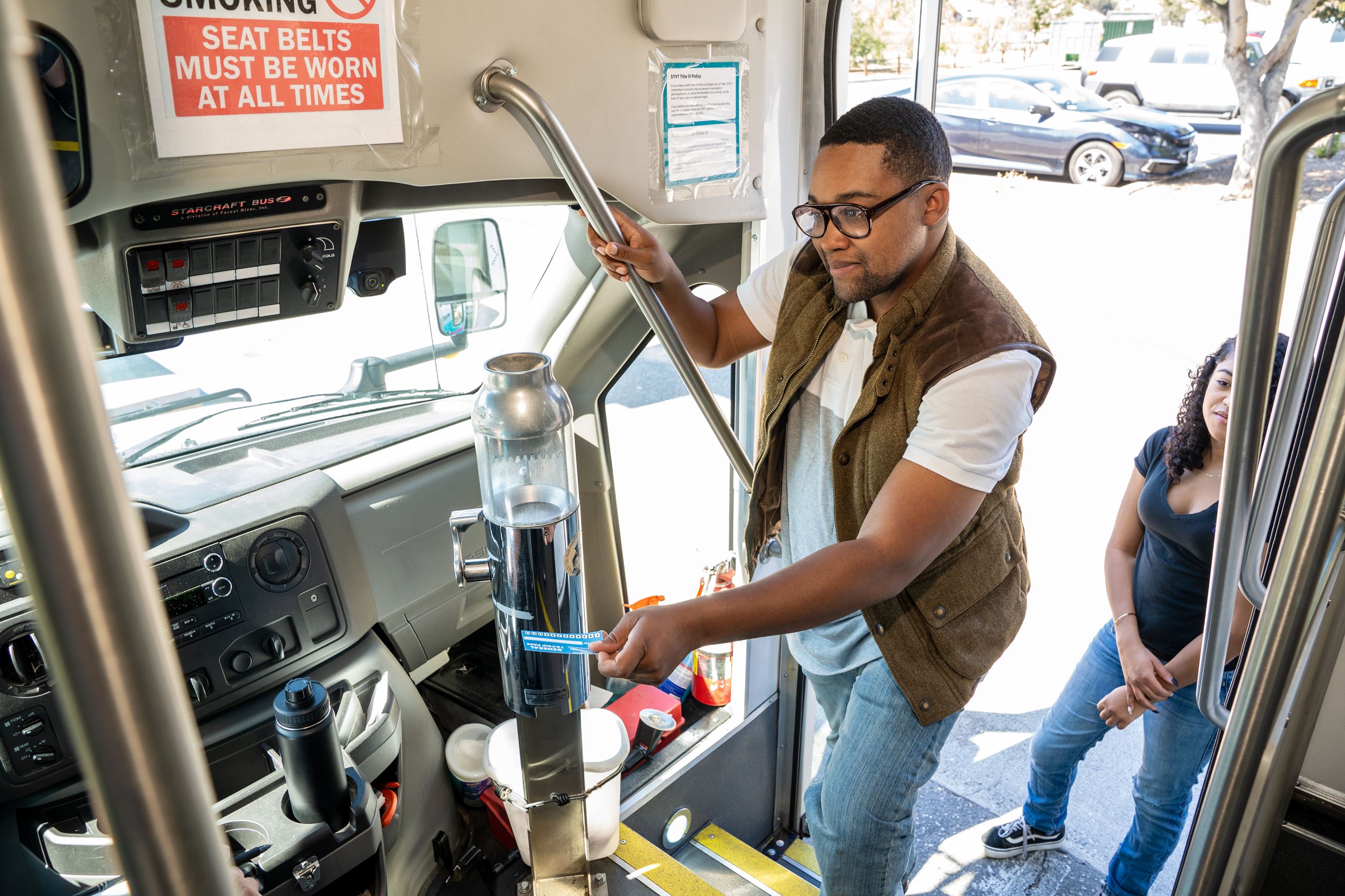 A customer boarding an SYVT bus and paying with a pass.